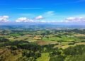 A serene landscape with rolling hills and blue sky.
