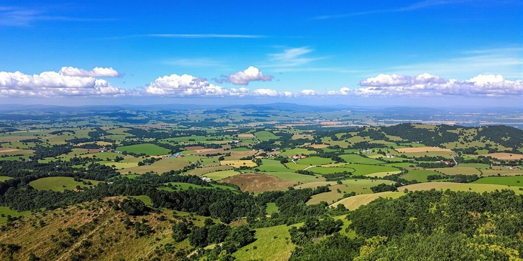 A serene landscape with rolling hills and blue sky.